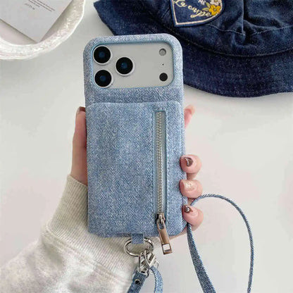 Blue denim-style crossbody phone case with a zipper wallet held by a hand on a light background