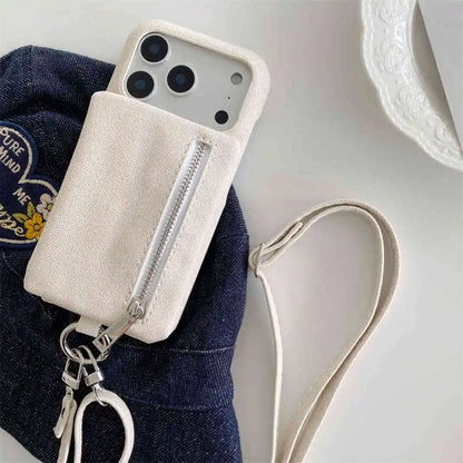 beige wallet Phone case with strap and ring on a denim surface