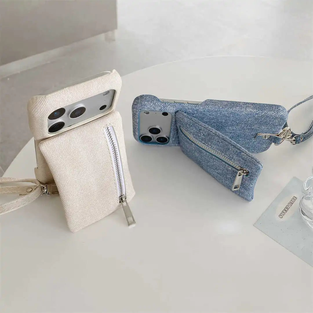 Two phone cases, one beige and one blue denim, on a white surface.
