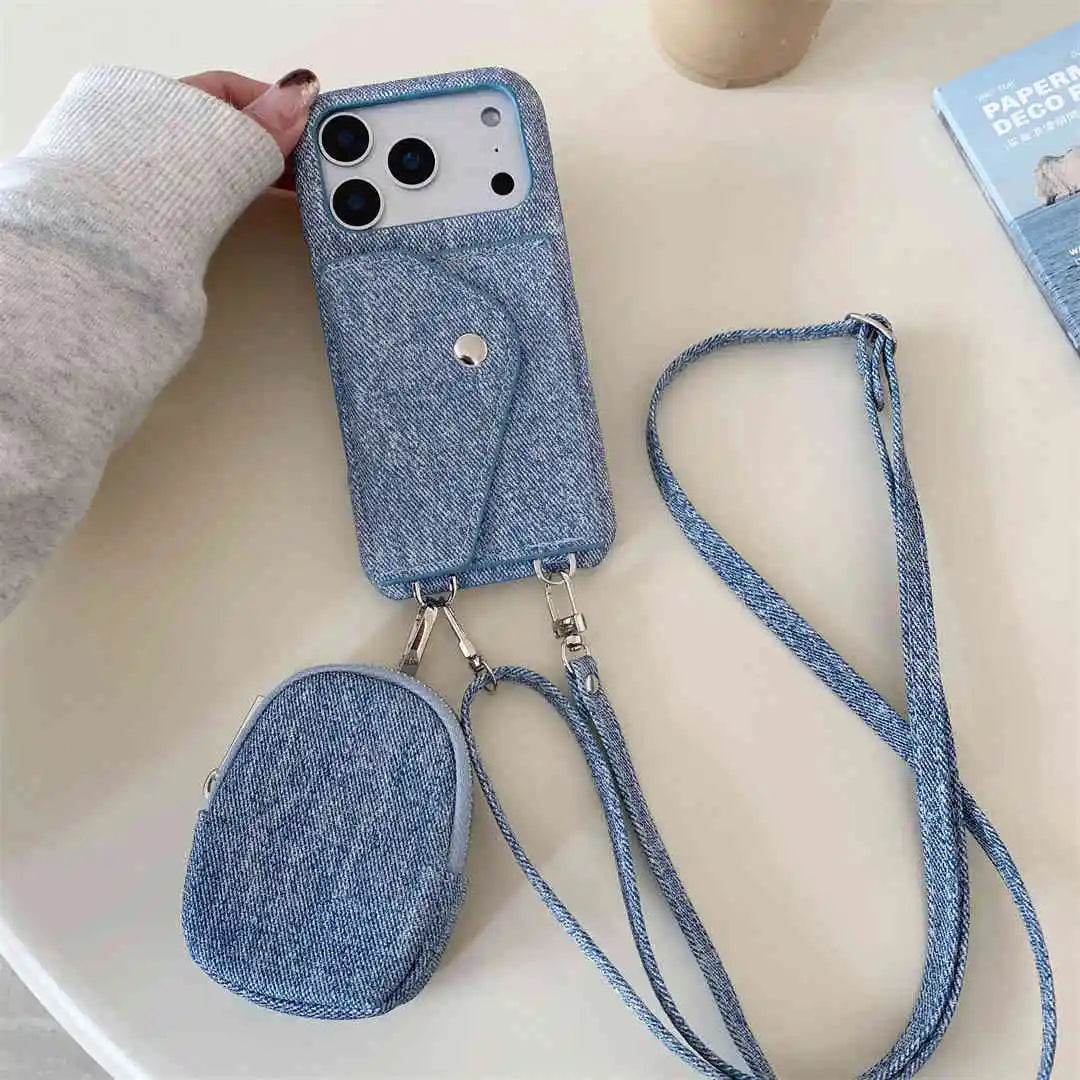Blue denim phone case with a small pouch and crossbody strap on a light surface.
