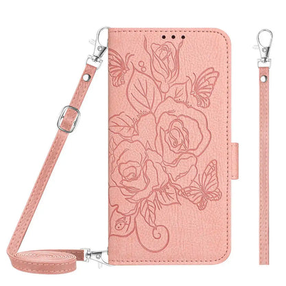 Pink folio wallet phone case with floral design and strap on a white background