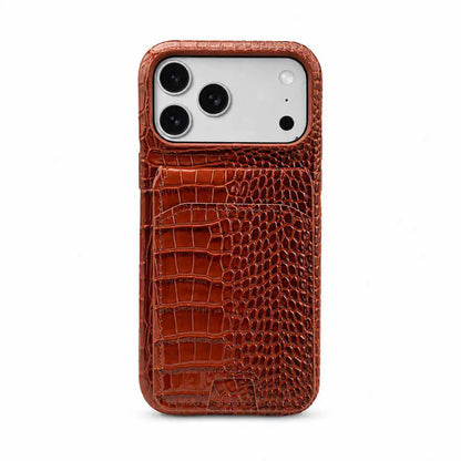 A brown crocodile-embossed leather phone case with a built-in card pocket, shown on a silver smartphone against a plain white background.