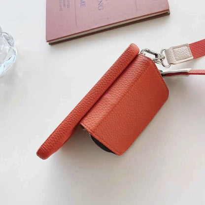 Red leather wallet with a strap on a light background