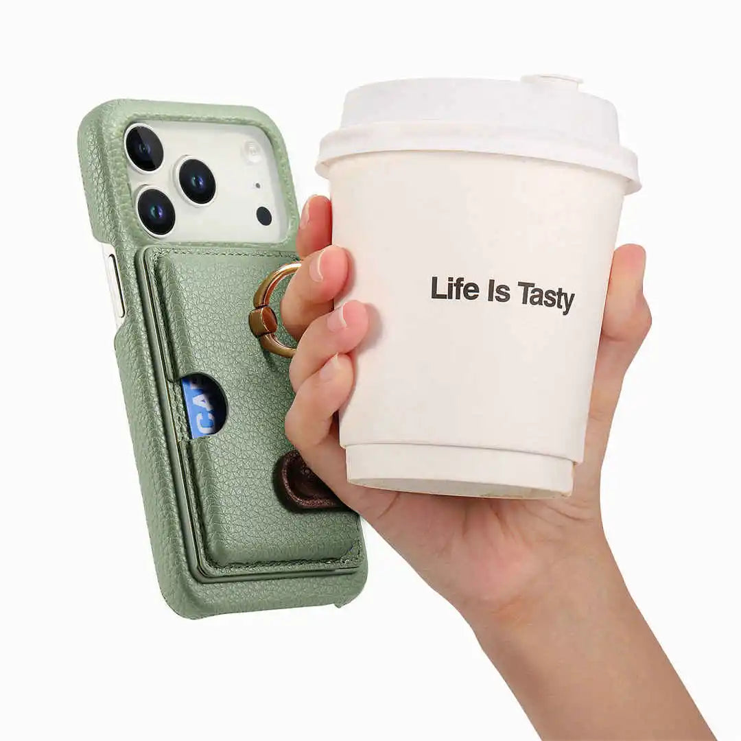 Hand holding a phone case with cup holder and a 'Life Is Tasty' coffee cup.