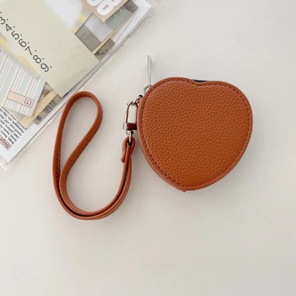 Brown heart-shaped pouch with a strap on a light surface