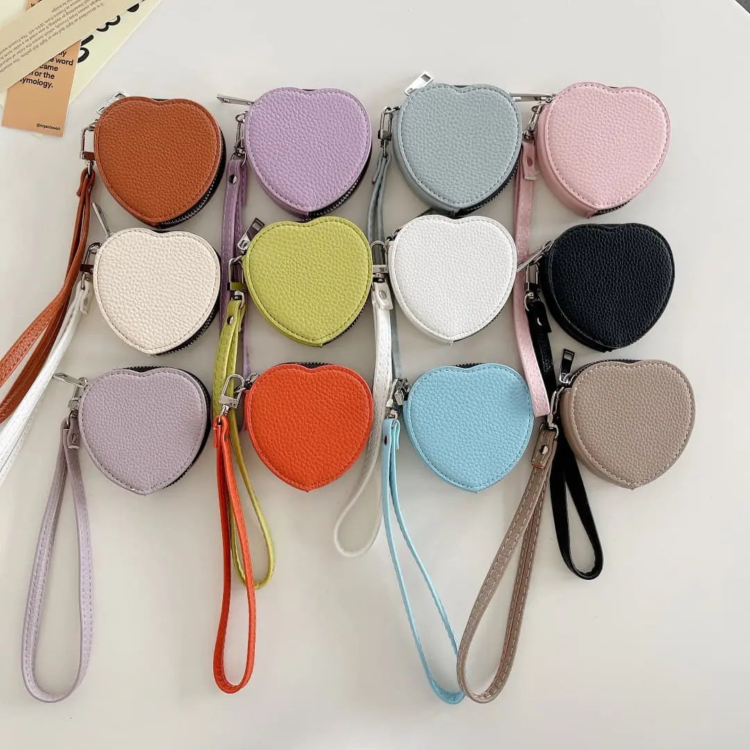 Heart-shaped airpods pouches in various colors on a white background