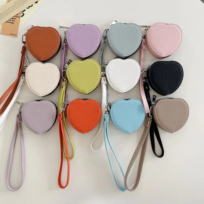 Heart-shaped airpods pouches in various colors on a white background