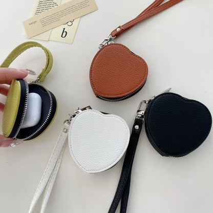 Heart-shaped coin purses in various colors on a light surface.