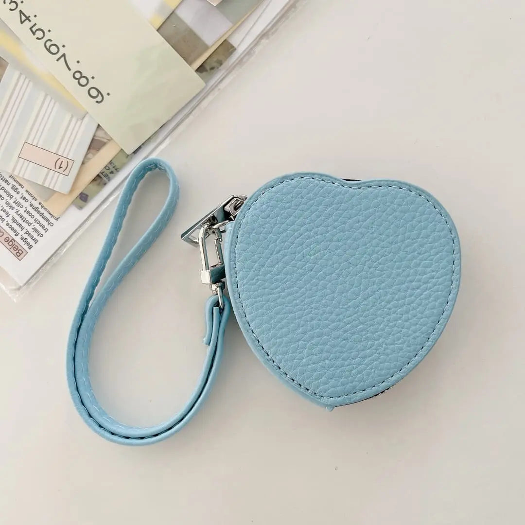 Heart-shaped blue pouch with a strap on a light background