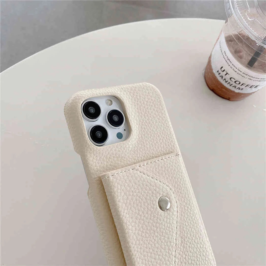 Phone case with a pocket on a white surface next to a coffee cup