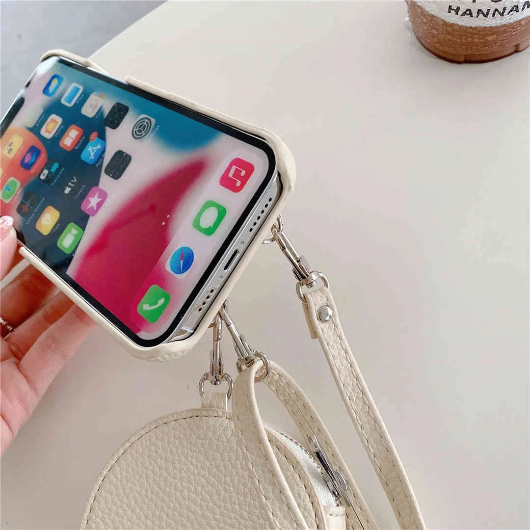 Phone case with a crossbody strap held by a hand on a light background