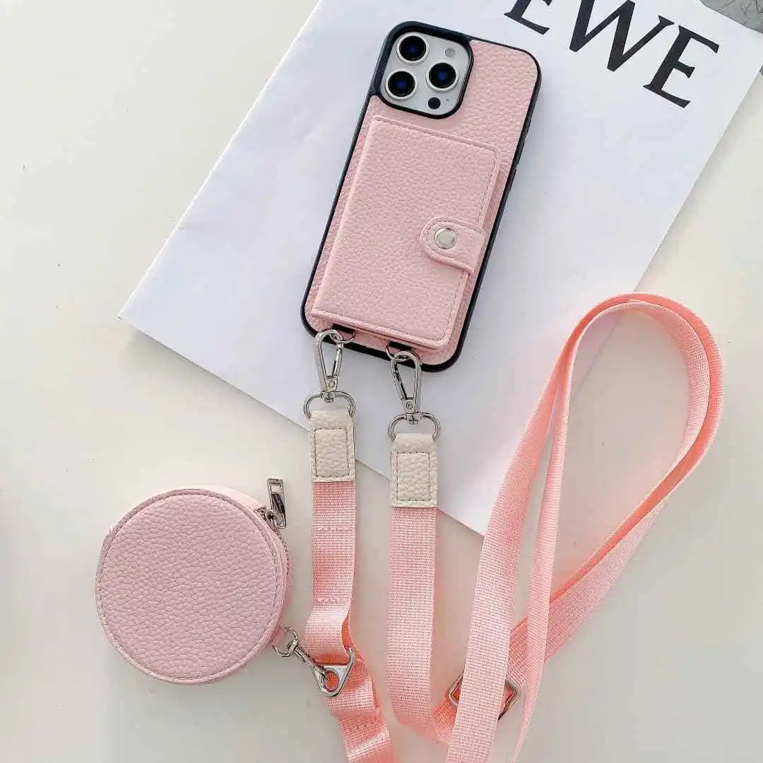 Pink wallet phone case with detachable strap on a white surface