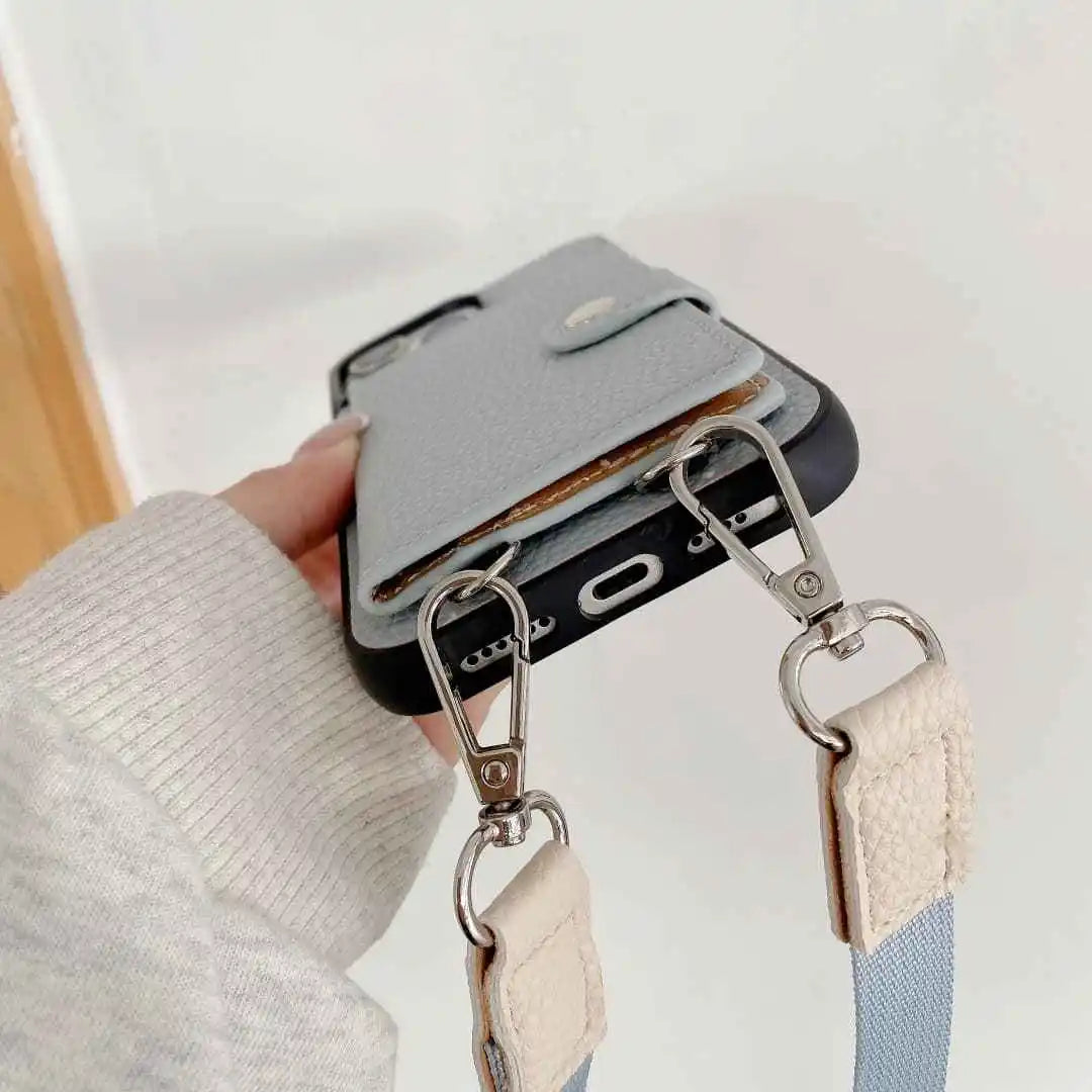 Phone case with a detachable strap held by a hand against a light background