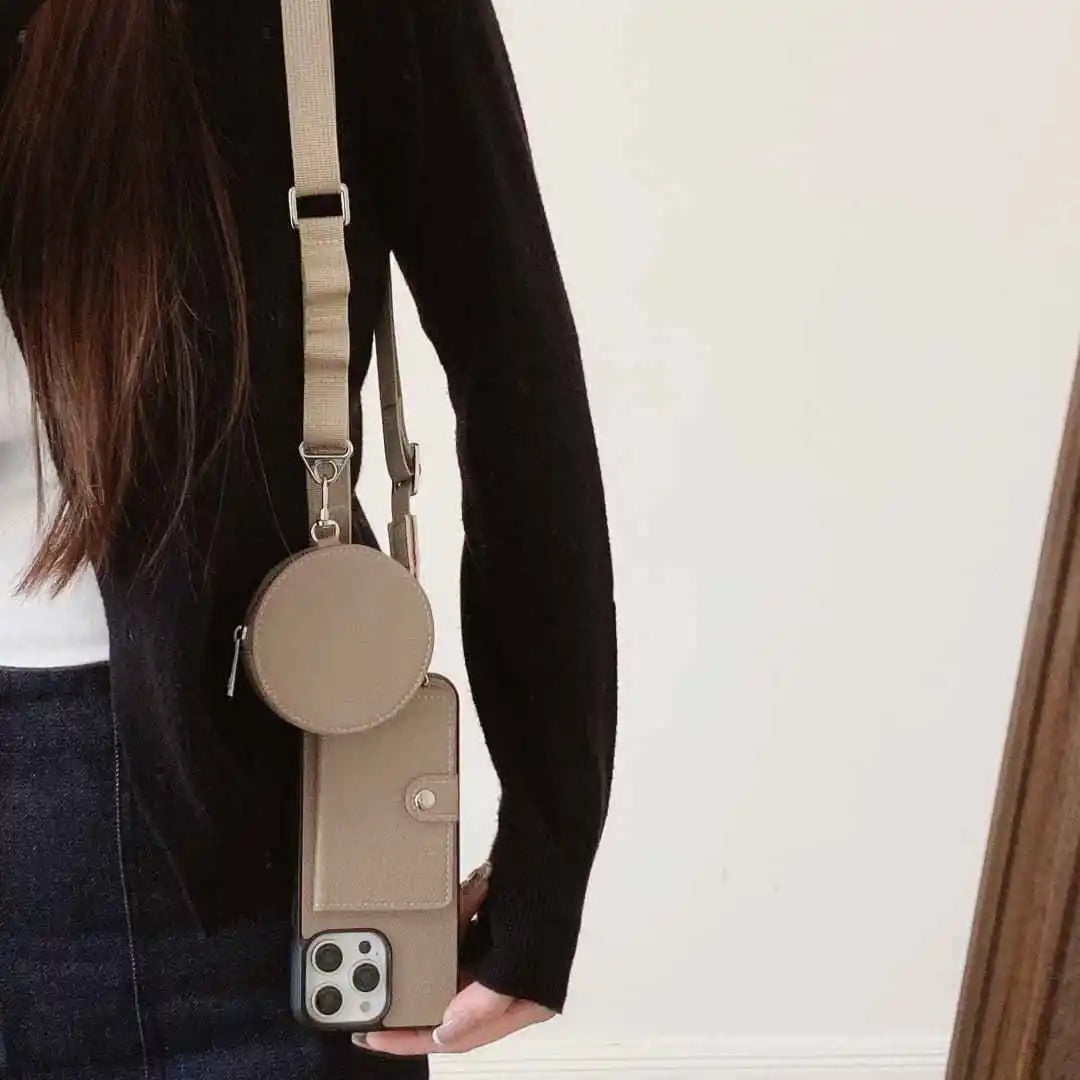 Person holding a beige crossbody phone wallet with a phone case attached