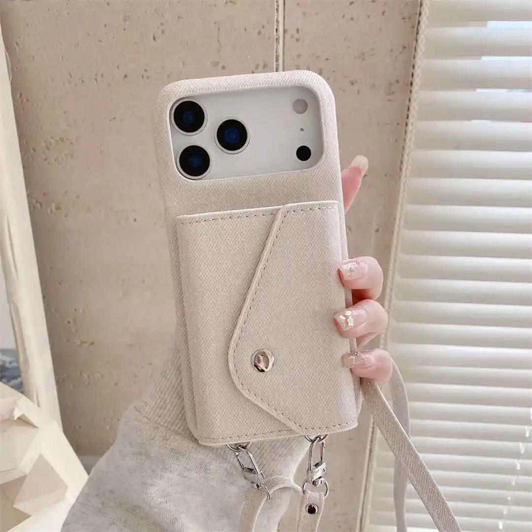 Beige wallet phone case with a strap held by a hand against a neutral background