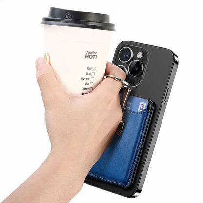 Hand holding a phone with a blue cardholder attached, next to a coffee cup.