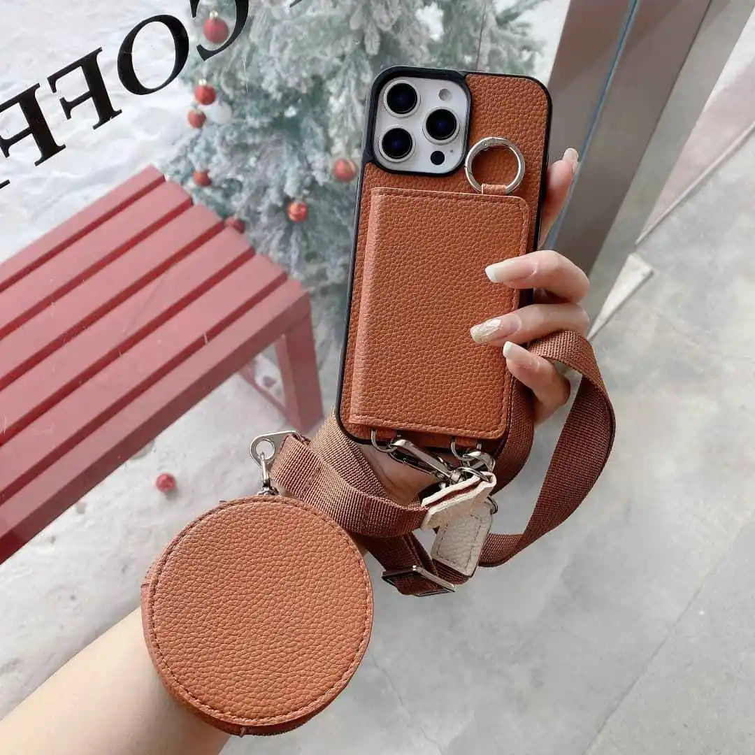 Brown wallet phone case with strap held by a hand, outdoor setting
