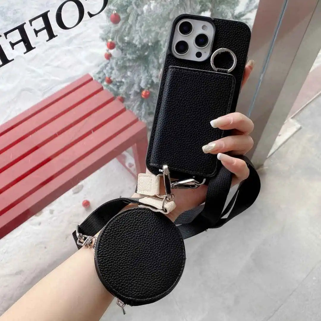 Black wallet phone case with a detachable strap held by a hand, with a blurred background.