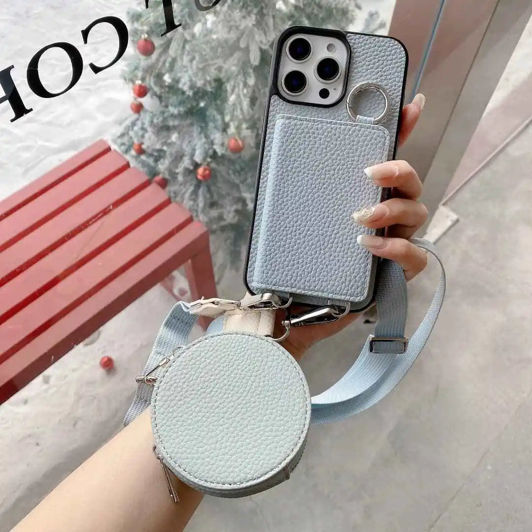 Light blue wallet phone case with detachable strap held by a hand, blurred background