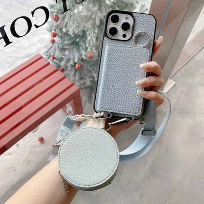 Light blue wallet phone case with detachable strap held by a hand, blurred background