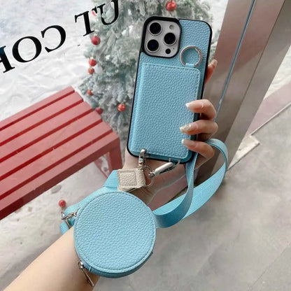 Blue wallet phone case with a matching round pouch held by a hand, Christmas tree in the background.