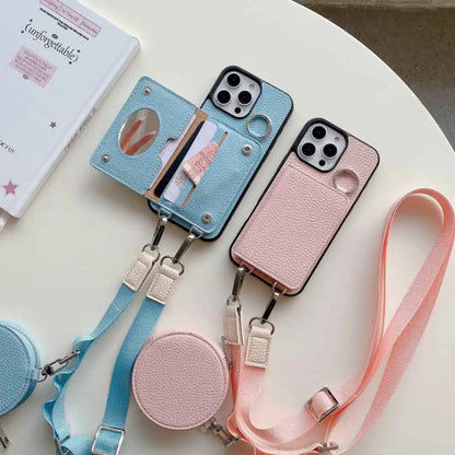 Two wallet phone cases with straps, one blue and one pink, on a light surface.