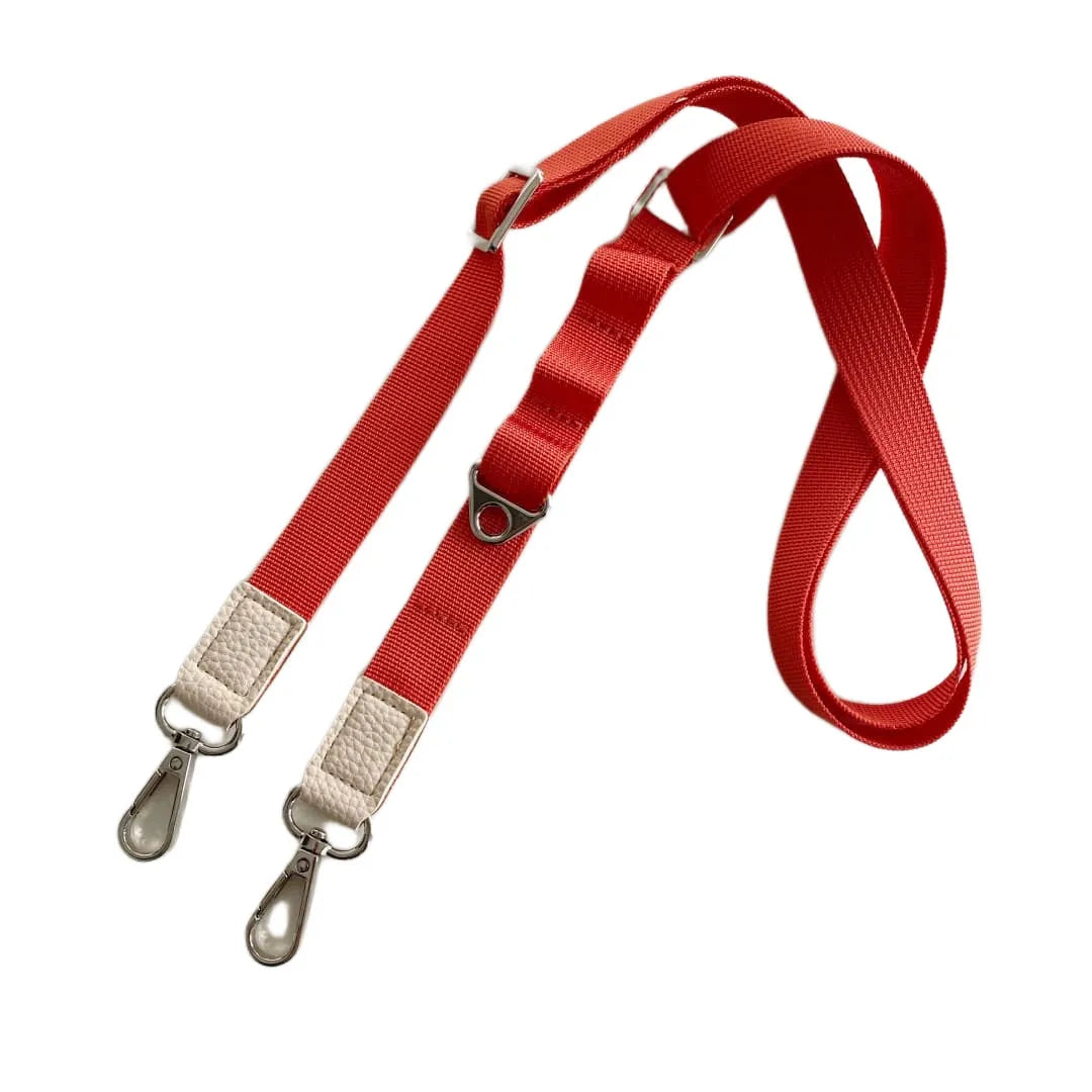 Red crossbody phone strap with beige ends and metal clips on a white background
