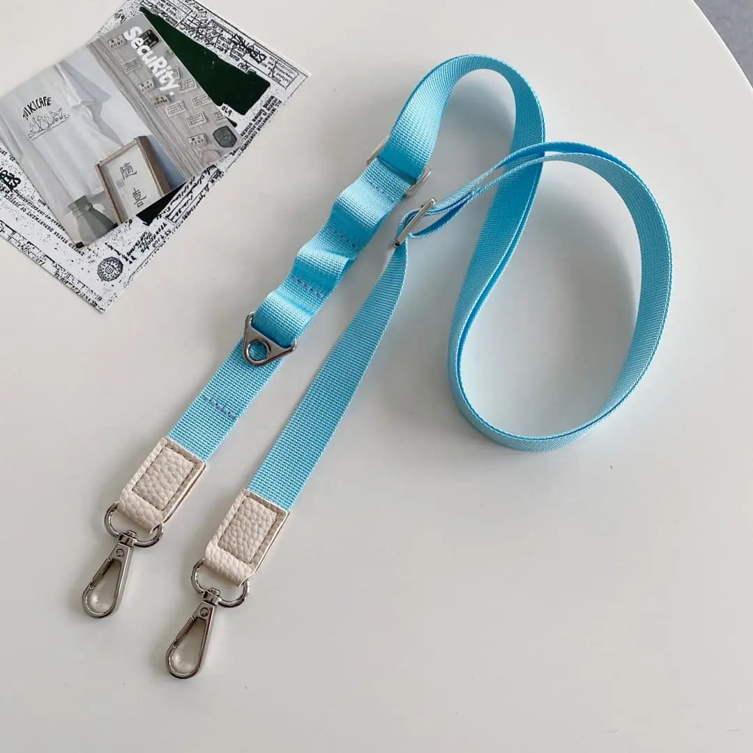 blue crossbody phone strap with metal clips on a light gray background