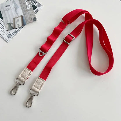 Red crossbody phone strap with metal clasps on a white background