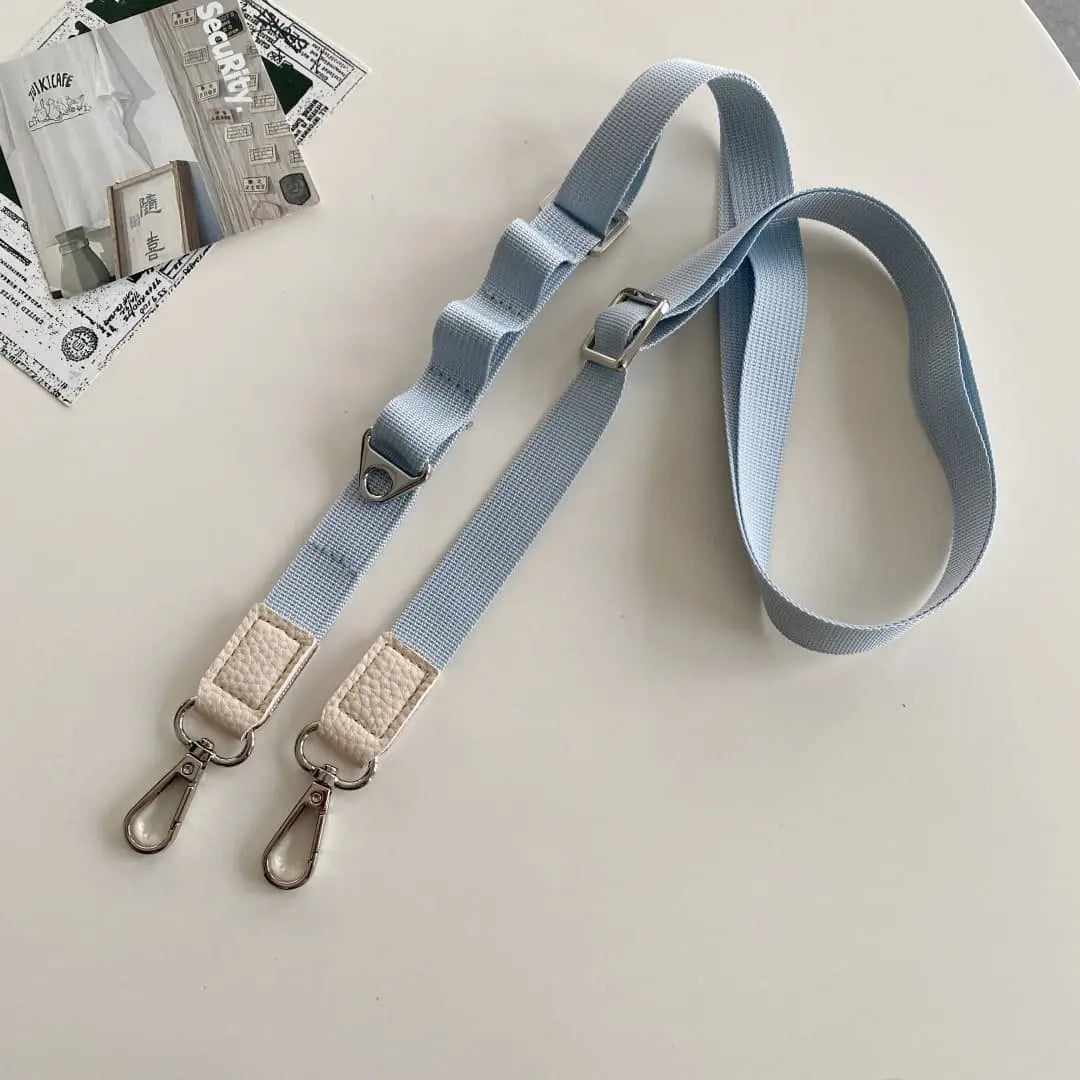 dusty blue strap with metal clasps on a light gray background