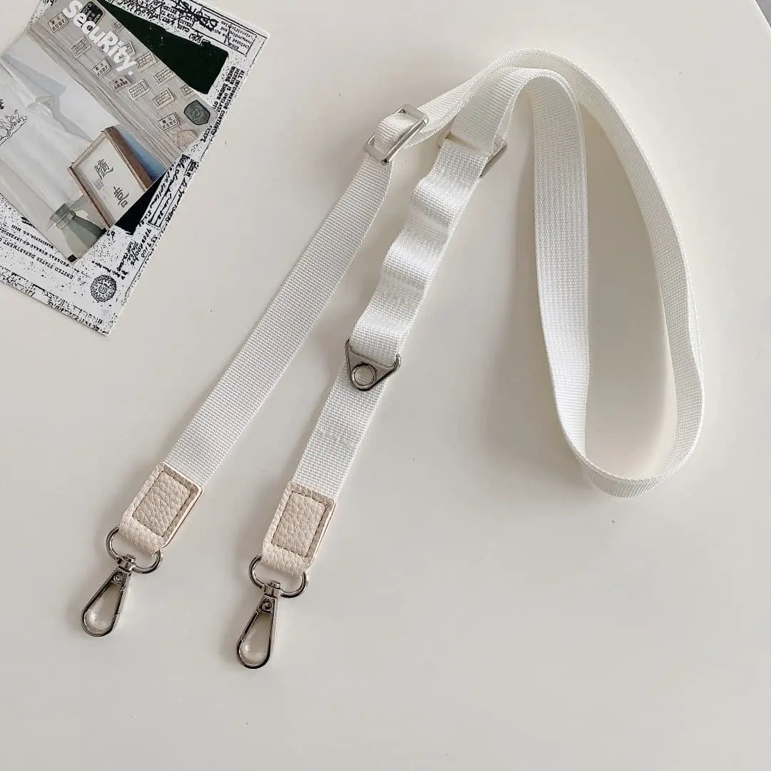 White crossbody strap with metal clasps on a white background