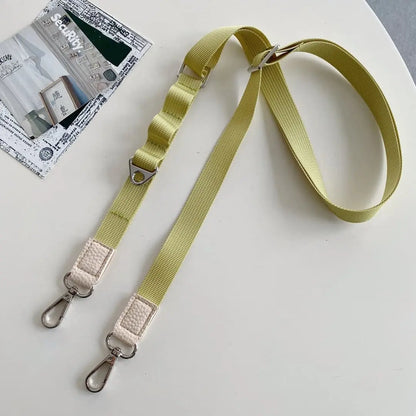 lime Green crossbody phone strap with metal hooks on a white surface