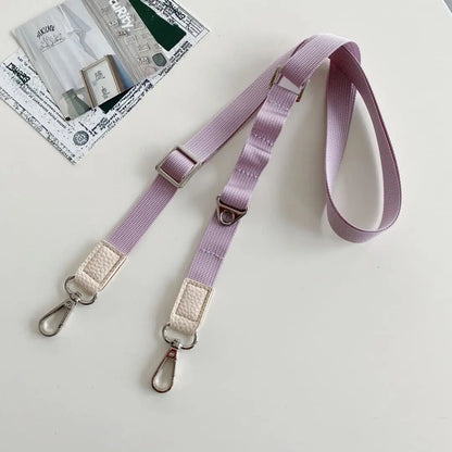 Pastel Purple crossbody strap with metal clasps on a light gray background