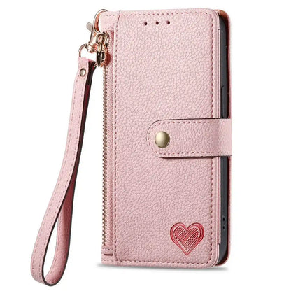 Pink phone case with a heart design and strap on a white background