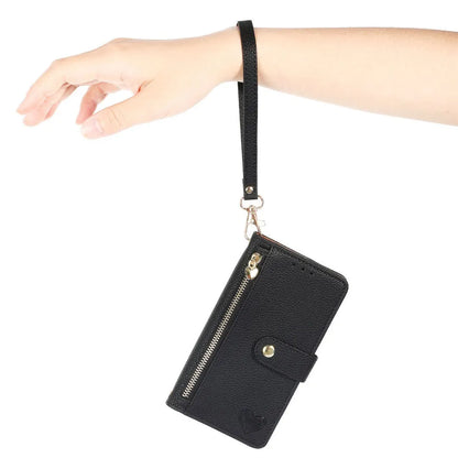 Black wristlet wallet case with strap held by a hand on a white background