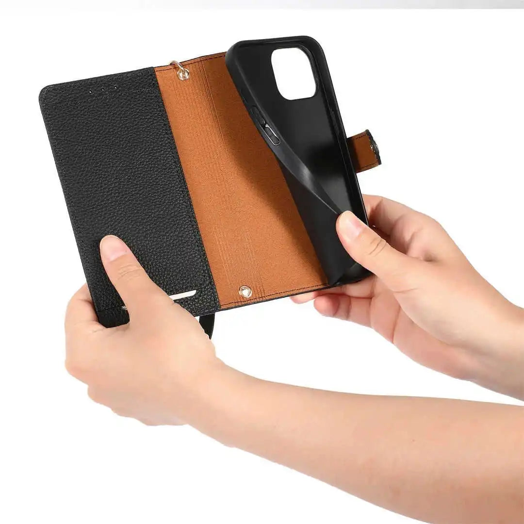 Phone case with black and brown leather design held by hands on a white background