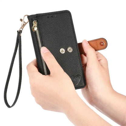 Black leather wallet case with a wrist strap held by hands on a white background